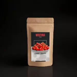 A packet of Wisitiria Seeds Cherry Tomato Seeds kept against a black background