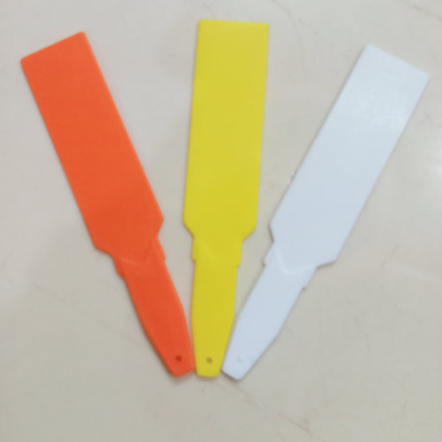 This is an image of three Arrow-Shaped Plant Tags of orange, yellow and white color kept against white color background.