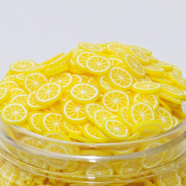 Several similar Miniature Polymer Clay Lemon in a glass bottle.