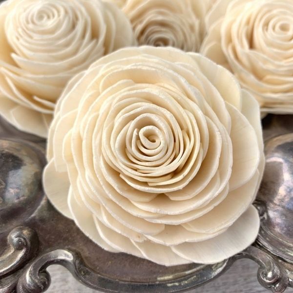 Flowers made of Natural Sola wood on a table.