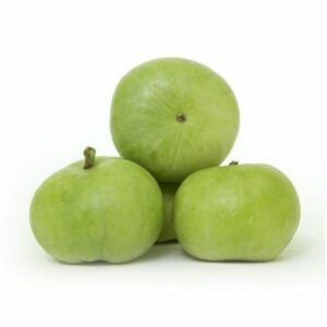 This is an image of several green tinda or round gourds kept in a heap against white color background.