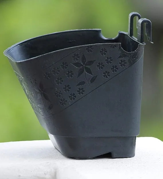 This is an image of a Vertical Wall Hanging Pot of black color kept against blur background.
